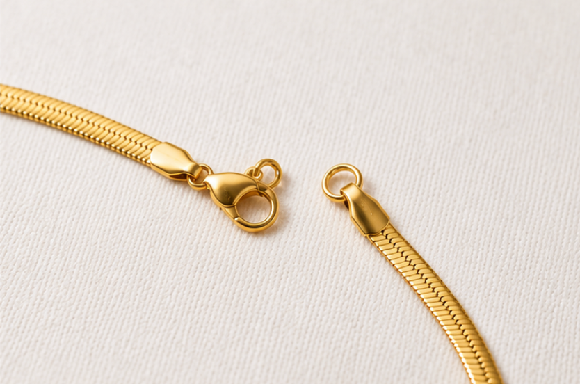 Gold chain with clasp on a light gray background