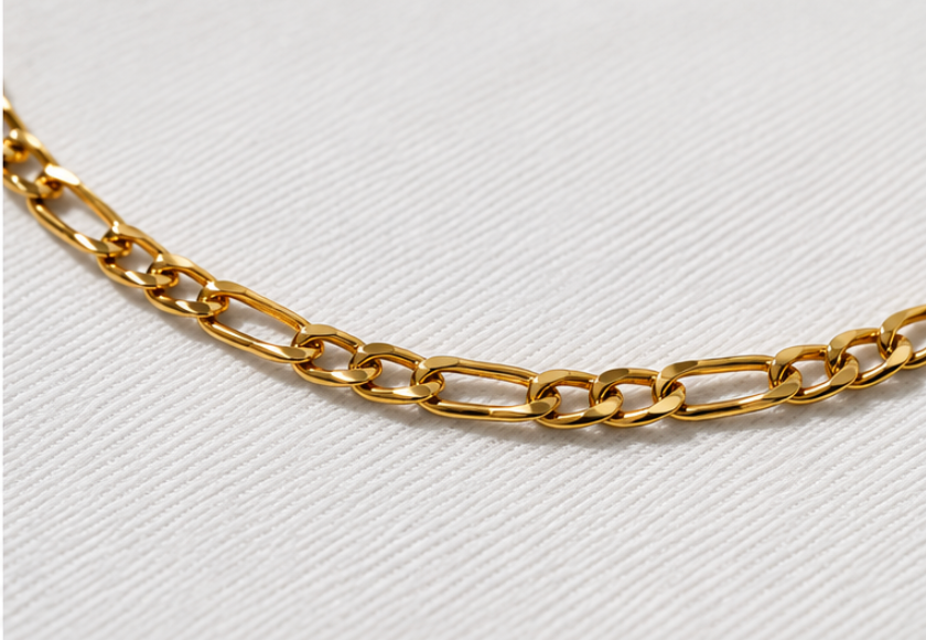 Gold chain on a light gray background